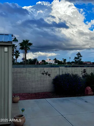 a backyard of a house with table and chairs