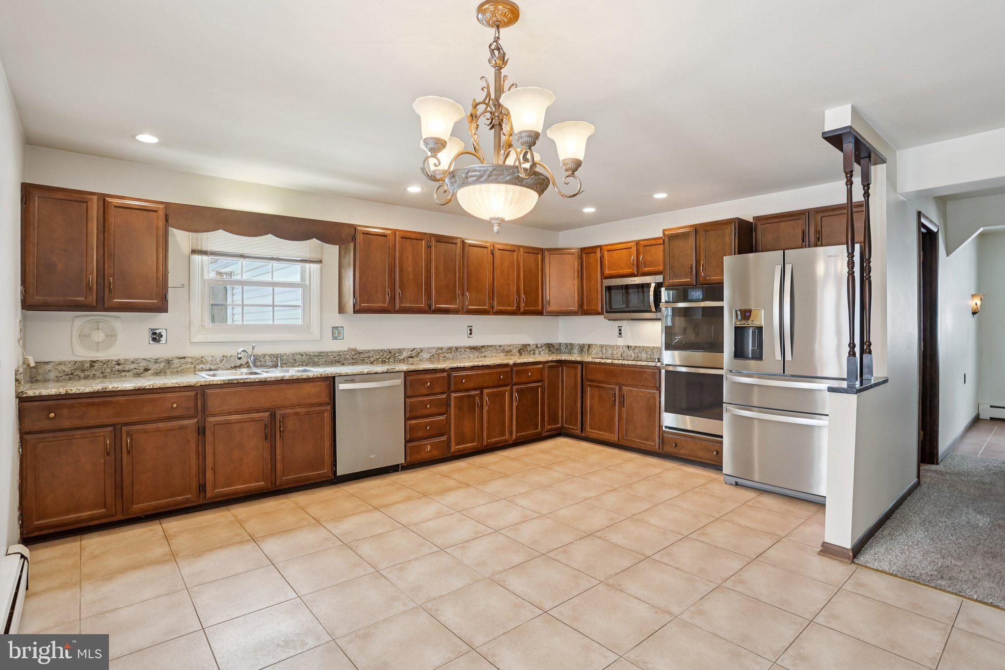 194 Long Lane Kirkwood, PA 17536 - Photo 3 of 56 a kitchen with granite countertop stainless steel appliances and wooden cabinets