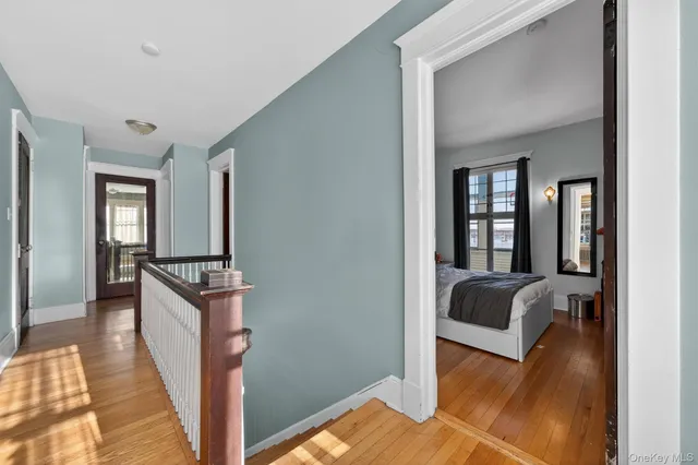 a view of a livingroom with a couch and wooden floor