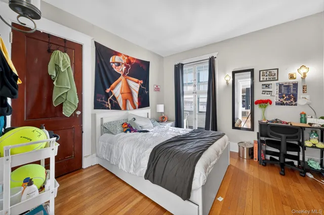 a bedroom with a bed and a desk