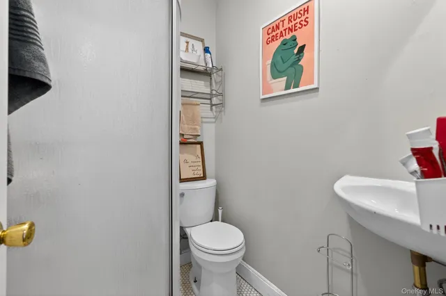 a white toilet sitting next to a bathroom sink