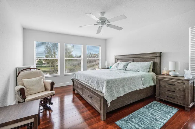 a bedroom with a bed a chandelier and a window