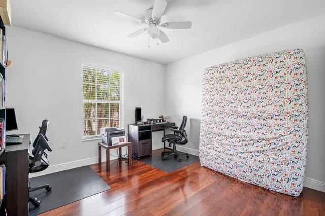 a view of a workspace with furniture and a window