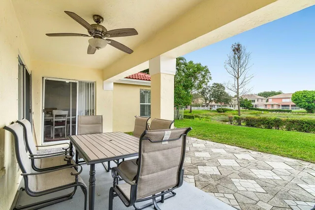 a view of a patio with a table and chairs