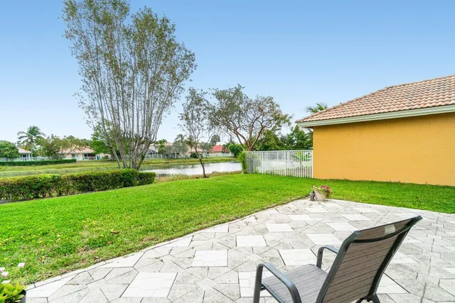 a view of a backyard with a garden and entertaining space