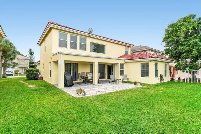 a front view of a house with a yard table and chairs