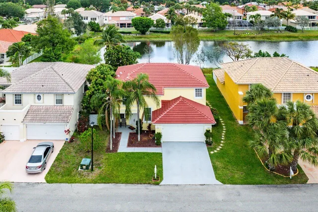 an aerial view of residential houses and lake view