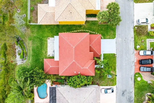 an aerial view of a house with a garden and a yard