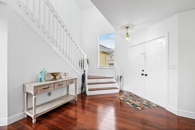 a room with stairs and wooden floor