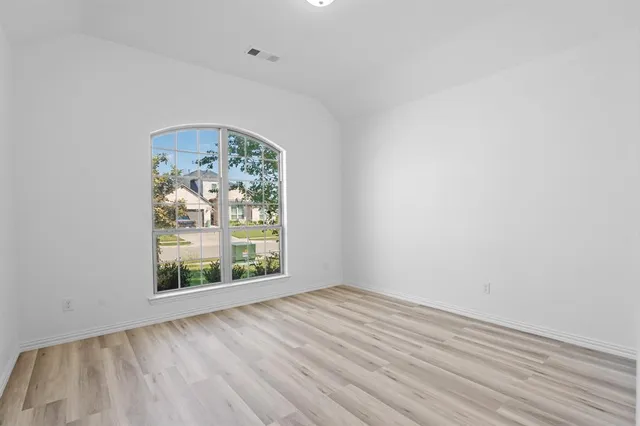a view of room with wooden floor and fan