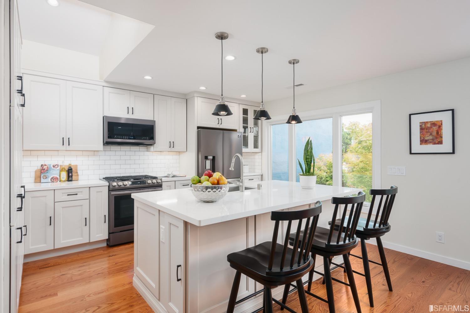 Molimo Drive San Francisco, CA 94127 - Photo 13 of 53 a kitchen with stainless steel appliances granite countertop a stove a sink a microwave a refrigerator a dining table and chairs with wooden floor