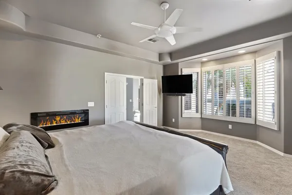 a bedroom with a large bed and a tv