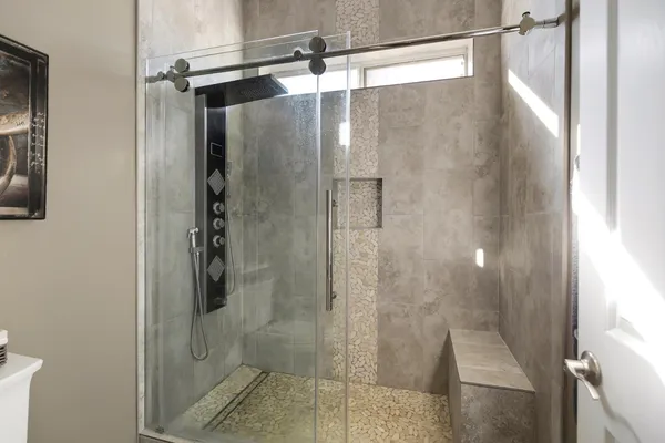 a bathroom with a glass shower door