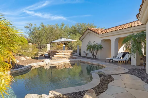 a swimming pool with outdoor seating and yard