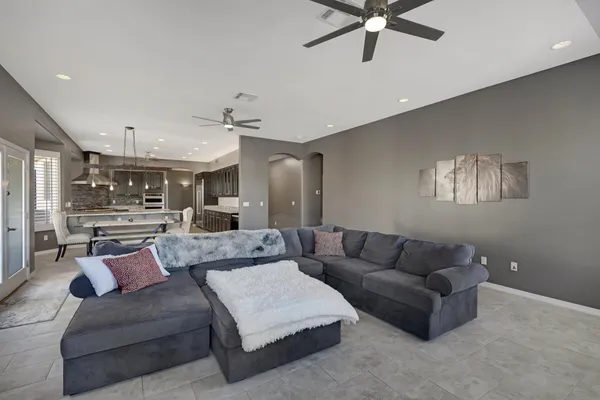 a living room with furniture and a ceiling fan