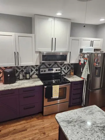 a kitchen with a stove a sink and a refrigerator