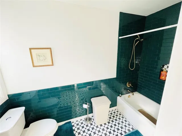 a bathroom with a toilet a sink and shower