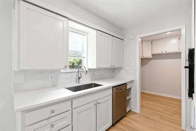 a kitchen with a sink and cabinets