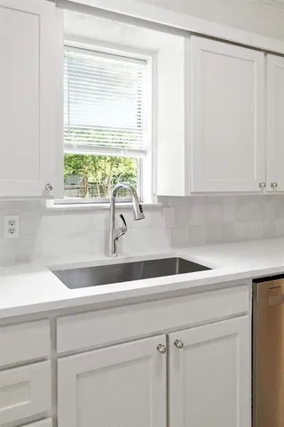 a kitchen with a sink and a window