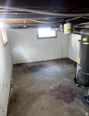 3161 Adams Avenue Ogden, UT 84403 - Photo 12 of 17 Unfinished basement space featuring concrete walls, exposed ceiling joists, and two small windows