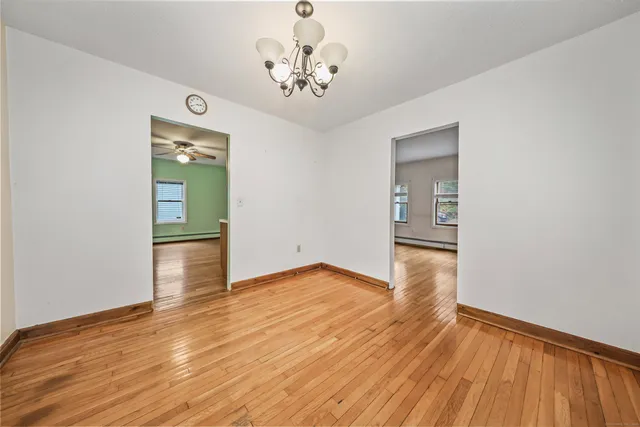 a view of livingroom with hallway and wooden floor