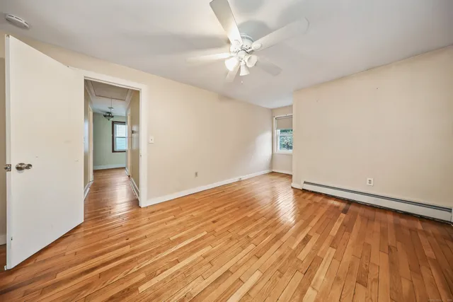 wooden floor in an empty room with a window