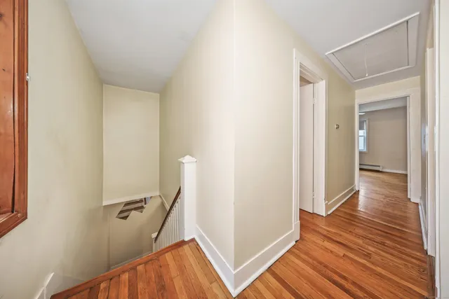 a view of a room with wooden floor and staircase