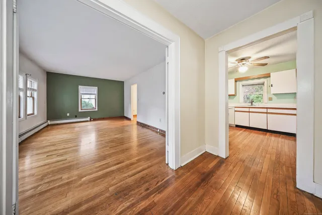 wooden floor in an empty room with a window
