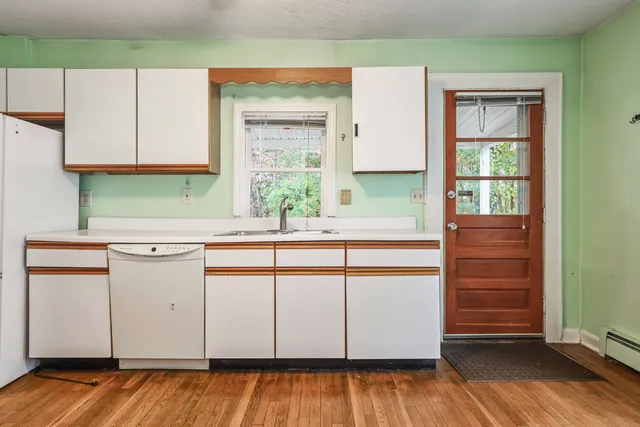 a kitchen with a sink cabinets and window