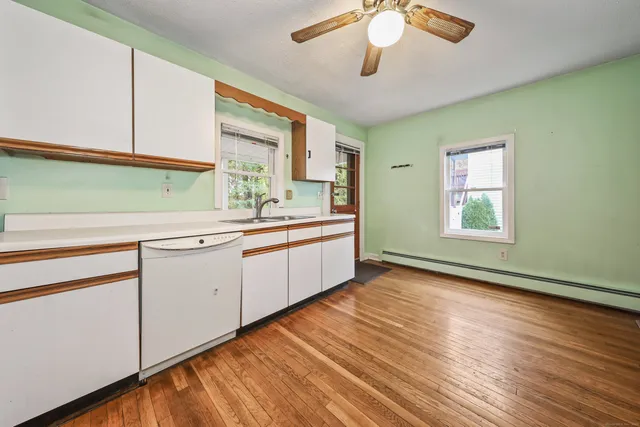 a kitchen with a sink cabinets and window