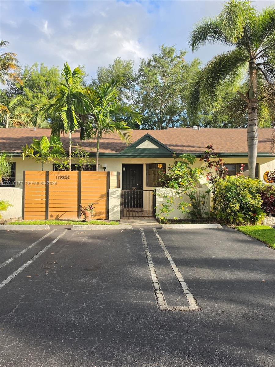 10908 Southwest 72nd Street, Unit 215 Miami, FL 33173 - Photo 1 of 25 a front view of a house with a yard and garage