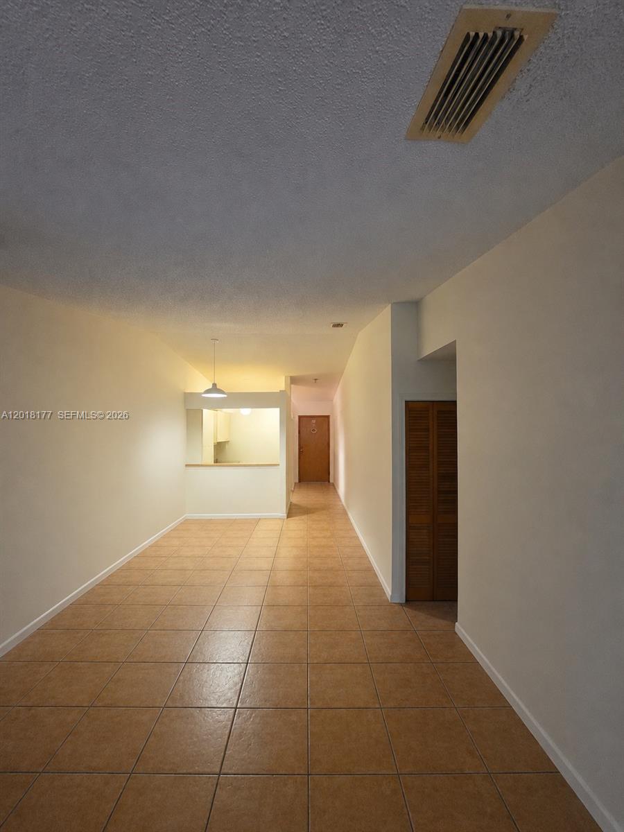 10908 Southwest 72nd Street, Unit 215 Miami, FL 33173 - Photo 21 of 25 a view of empty room with wooden floor and cabinet