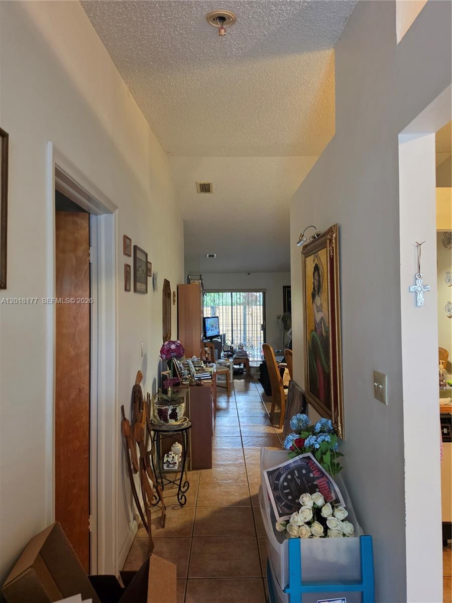 10908 Southwest 72nd Street, Unit 215 Miami, FL 33173 - Photo 7 of 25 a living room with furniture and a flat screen tv