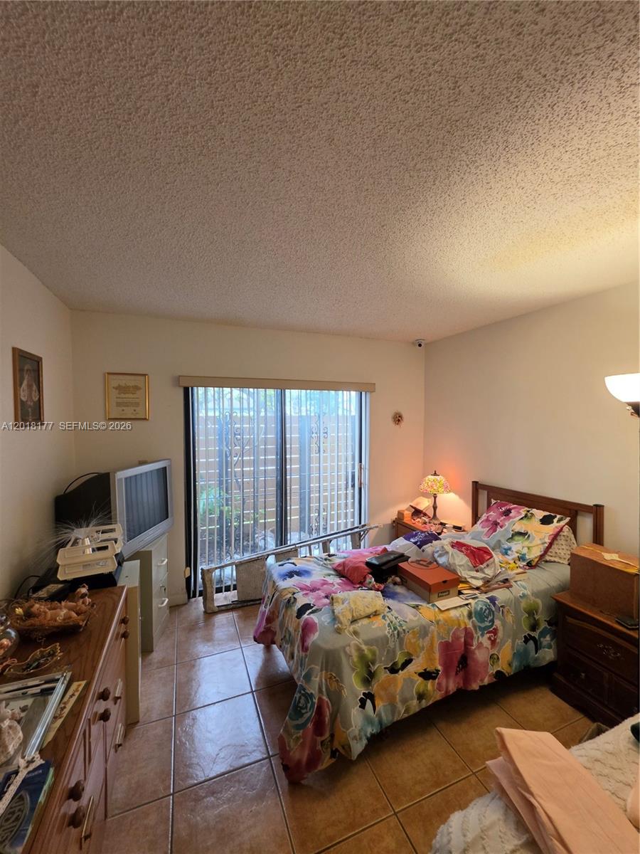 10908 Southwest 72nd Street, Unit 215 Miami, FL 33173 - Photo 9 of 25 a bedroom with a bed and a window