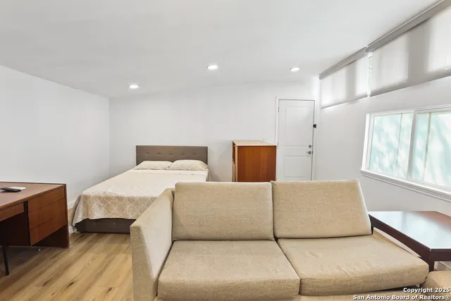 a bedroom with a bed and a night stand