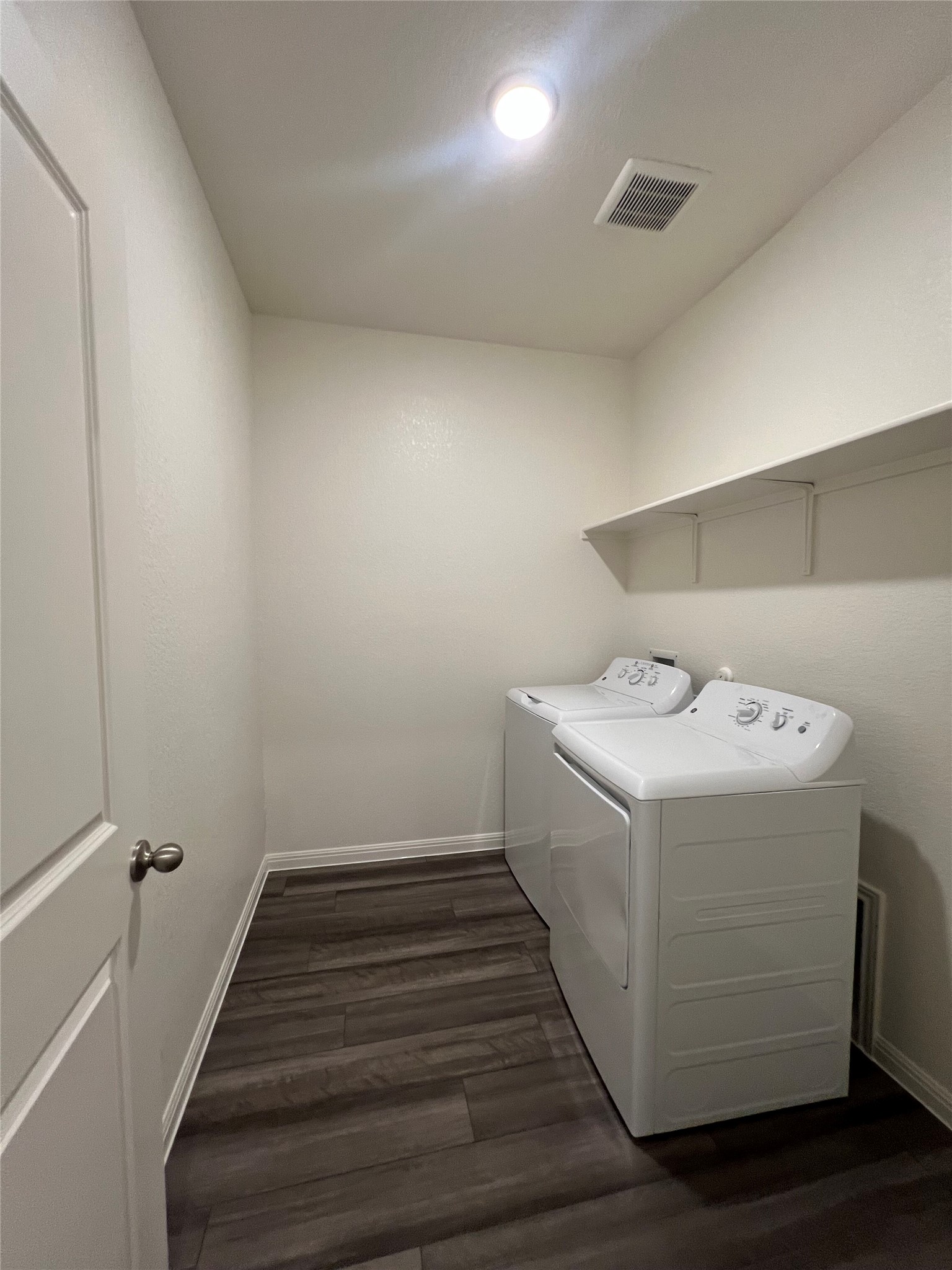 124 Rother Place Taylor, TX 76574 - Photo 7 of 12 Functional utility space with durable flooring and convenient laundry appliances.