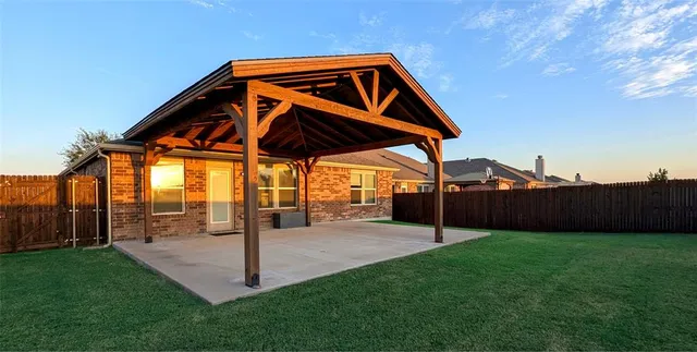 a view of a backyard with a garden and deck