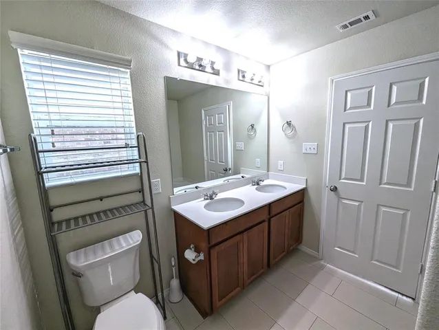 a bathroom with a sink a toilet and mirror