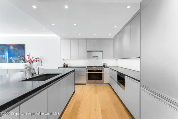 a kitchen with granite countertop sink stainless steel appliances and cabinets