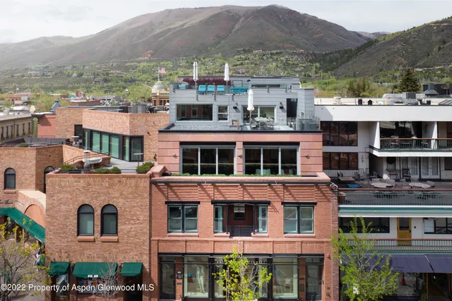 a view of a large building with a mountain