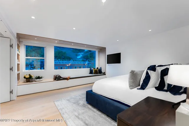 a bedroom with a large bed and a couch