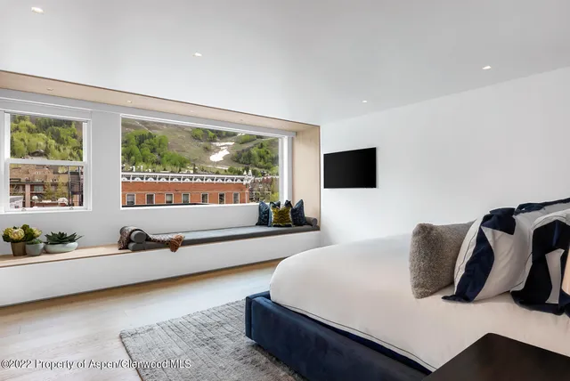 a bedroom with furniture and a flat screen tv