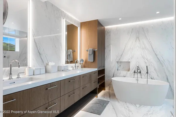a spacious bathroom with a bathtub and a sink