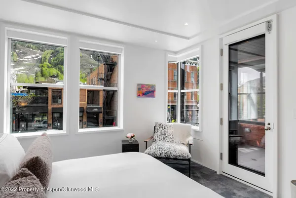 a spacious bedroom with a bed and a large window