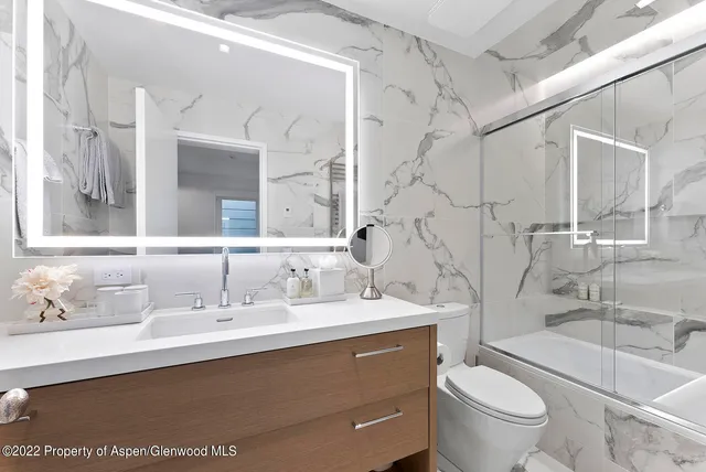 a bathroom with a sink vanity and a mirror