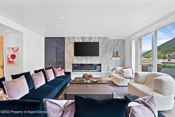 a living room with furniture fireplace and a flat screen tv