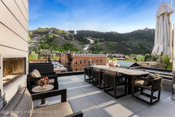 a outdoor living space with furniture and a fireplace