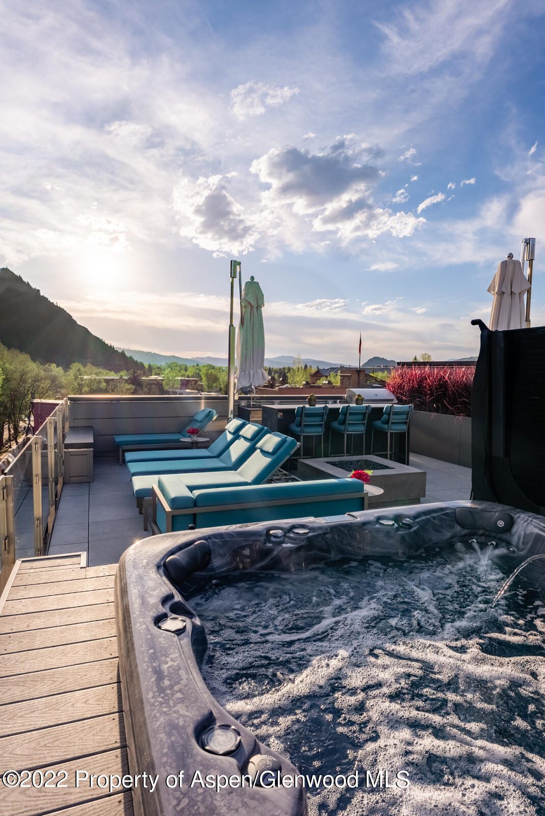508 East Cooper Avenue, Unit 201 Aspen, CO 81611 - Photo 45 of 54 a view of a swimming pool with a table and chairs a fire pit