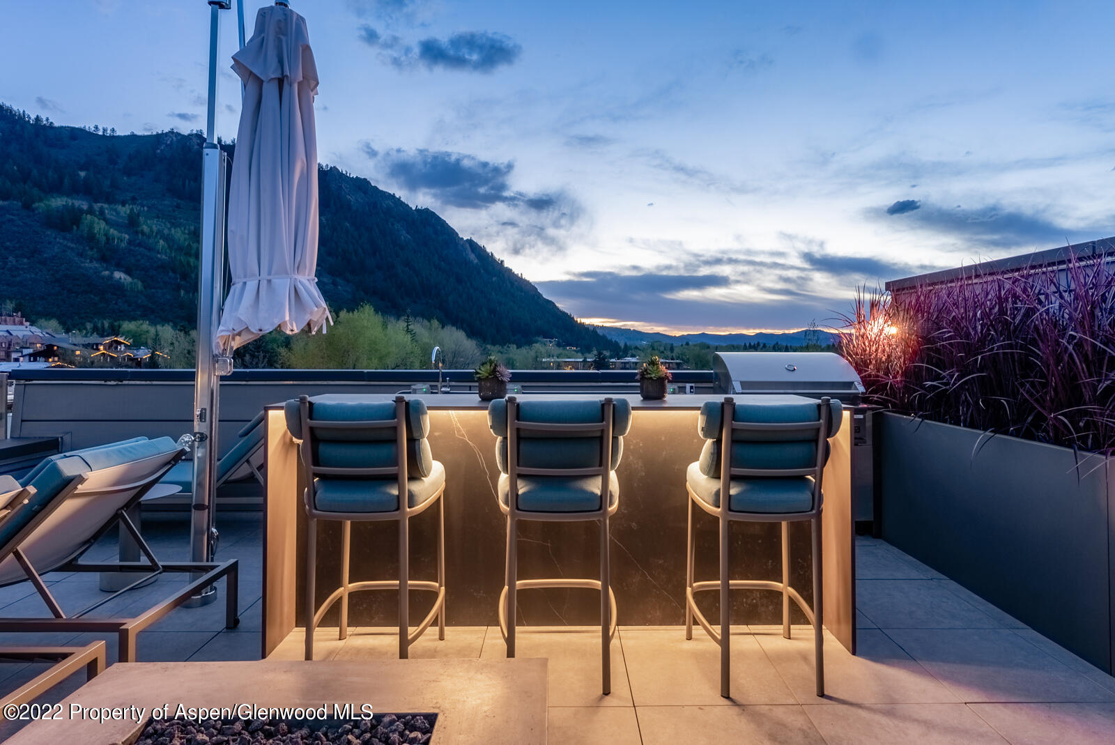 508 East Cooper Avenue, Unit 201 Aspen, CO 81611 - Photo 48 of 54 a table and chairs in front of a building