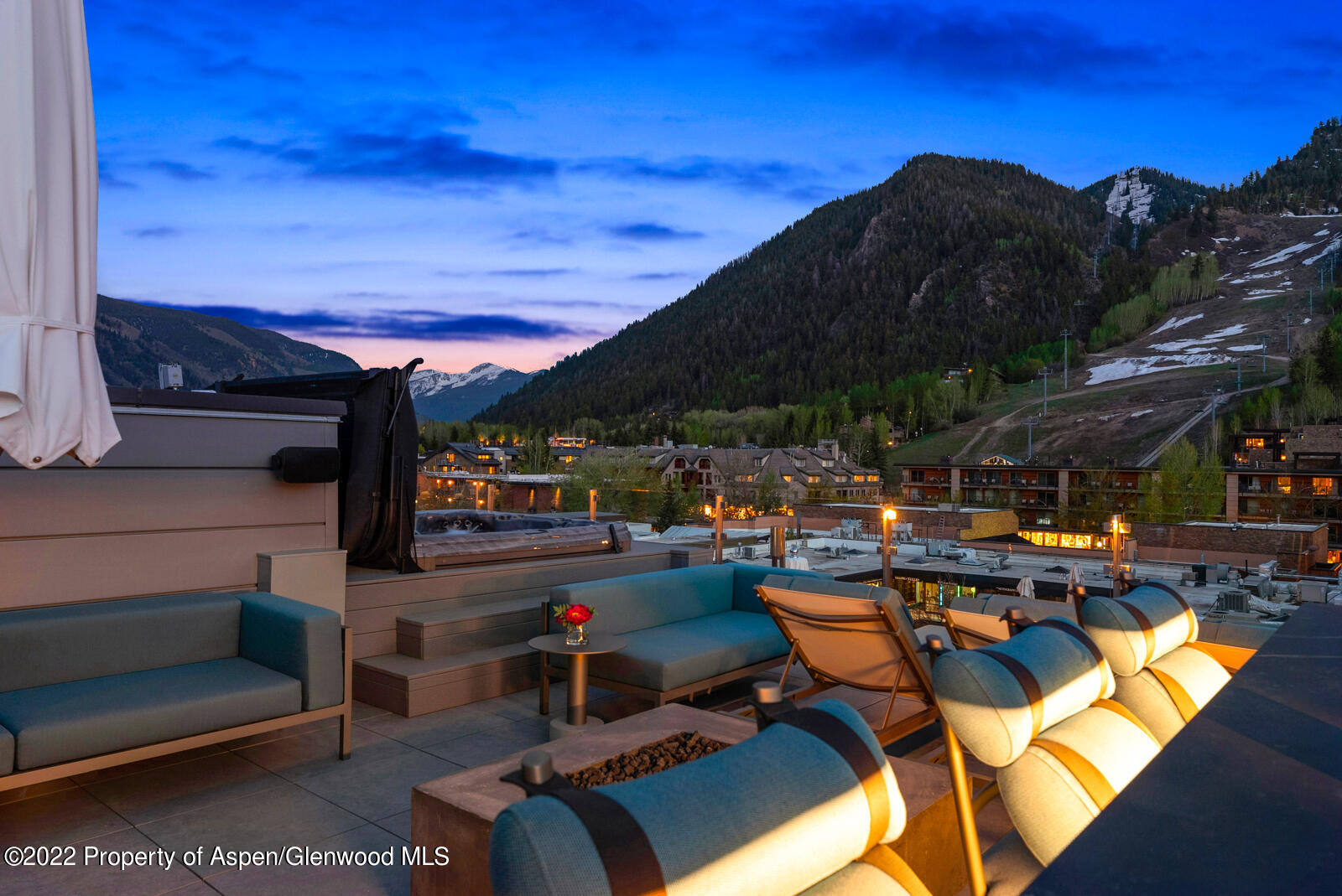 508 East Cooper Avenue, Unit 201 Aspen, CO 81611 - Photo 49 of 54 a view of a patio with table and chairs under an umbrella with a barbeque